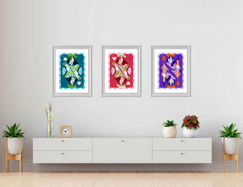 Three colourful printsfeatured against a white wall in a home
